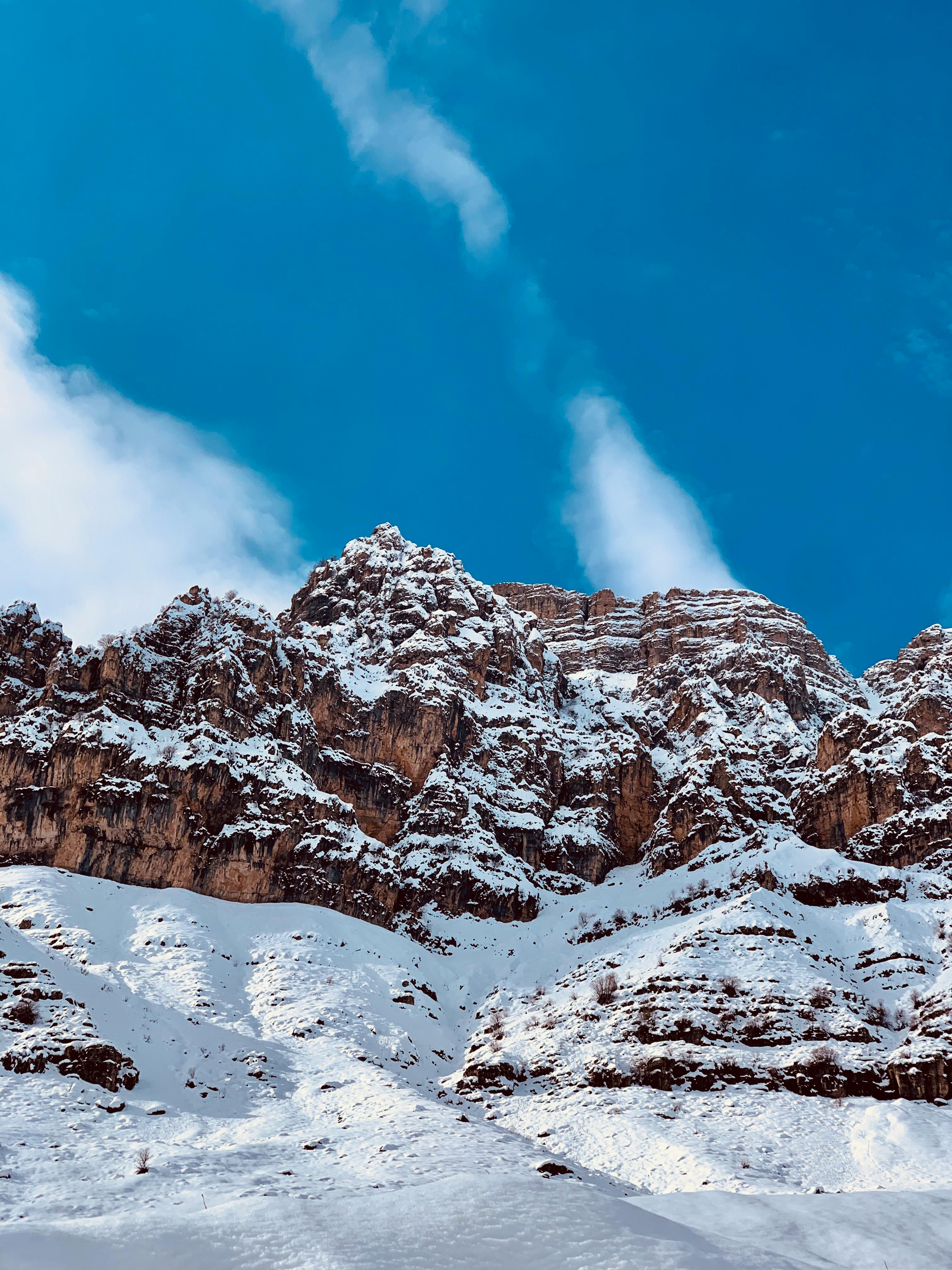 Prescription Goggle Inserts - Stunning view of snow-covered mountains with a bright blue sky backdrop, perfect for winter scenery.