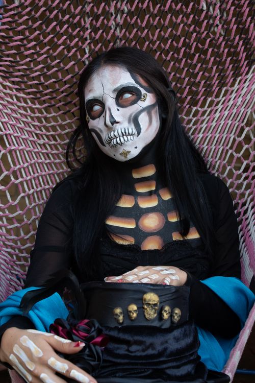 Free A vibrant Catrina costume with intricate face paint, celebrating Día de los Muertos in Mexico City. Stock Photo
