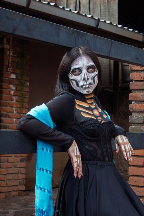 Free A woman dressed as a Catrina for Dia de los Muertos in Mexico City, displaying intricate face paint and costume. Stock Photo