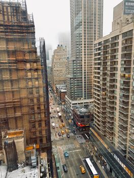 Aerial view of bustling streets in Midtown Manhattan, New York City, showcasing urban life.