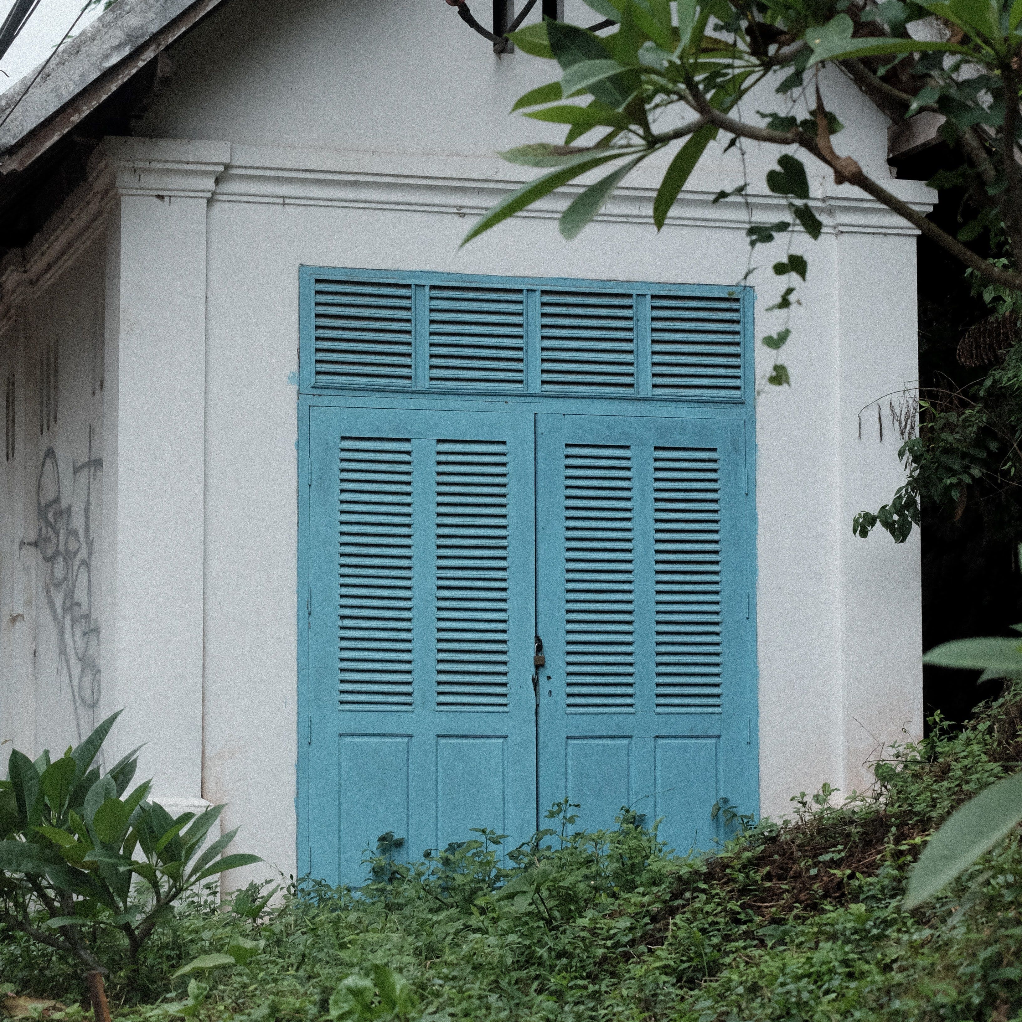 Charming Rustic Building with Blue Shutters · Free Stock Photo