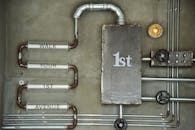 Industrial Pipe Art with Text on Concrete Wall