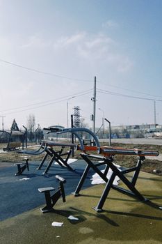 Outdoor fitness equipment in a winter park setting in Konaev, Kazakhstan.