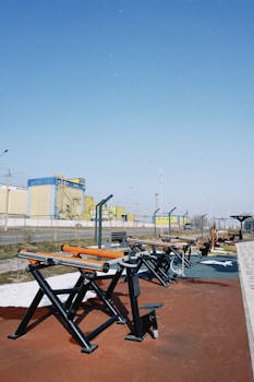 Fitness equipment in an outdoor gym setting on a sunny day in Konaev, Kazakhstan.