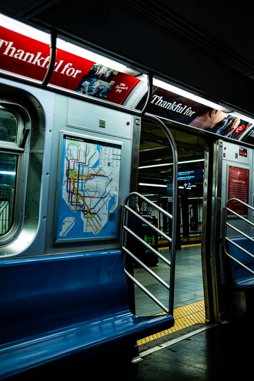 Free Empty New York City subway car with open doors, showcasing the interior and route map. Stock Photo