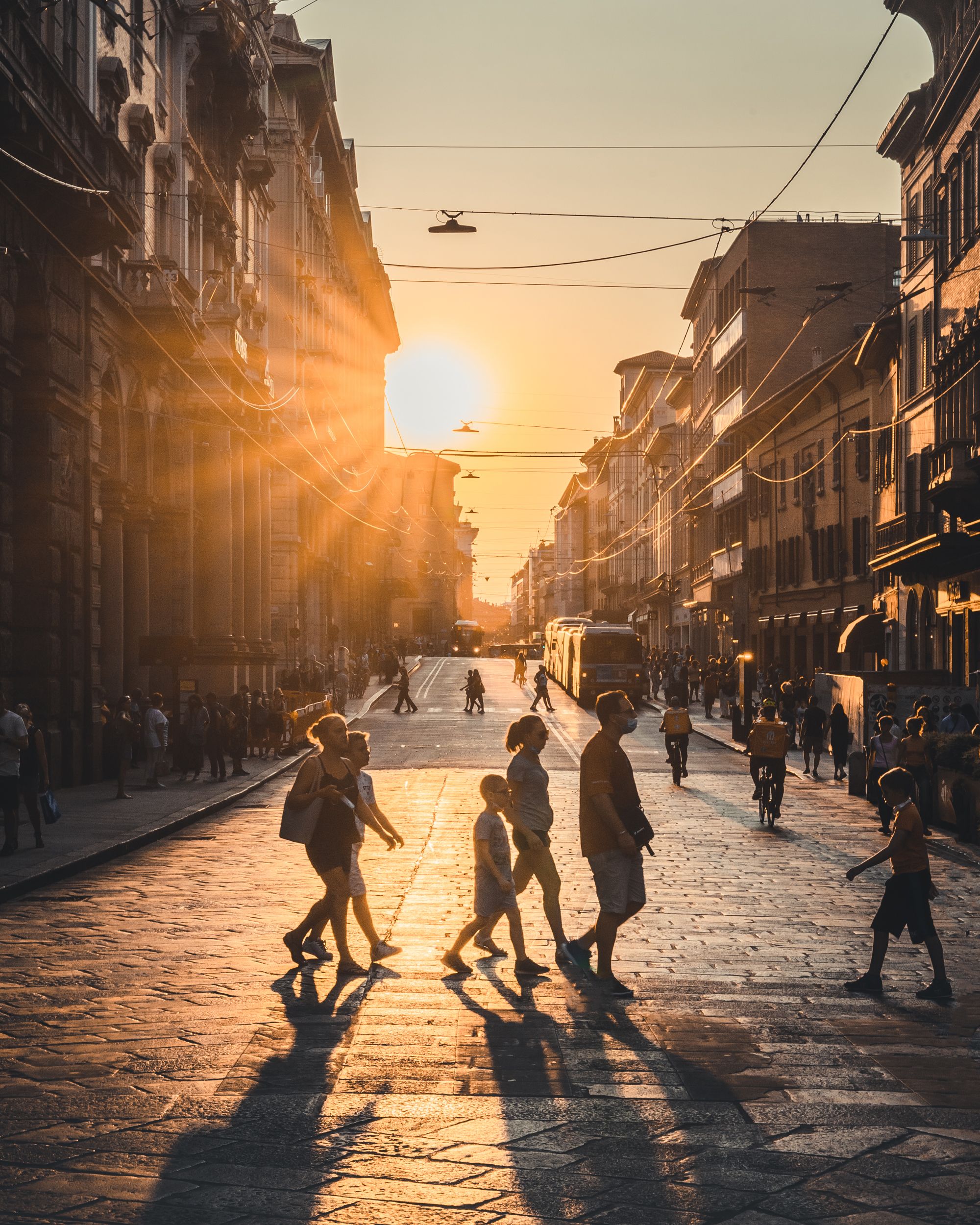 Sunset Street Scene with Silhouetted Pedestrians · Free Stock Photo