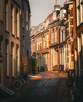 Idyllic European street scene captured during golden hour with classic architecture and bicycles.