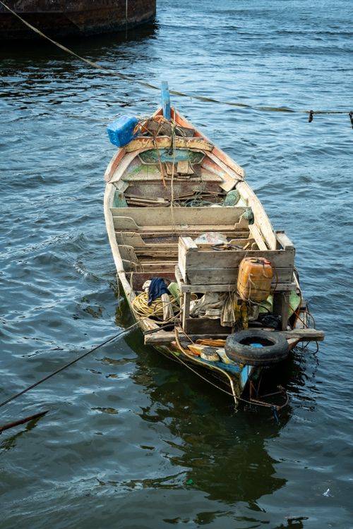 Free A rustic fishing boat anchored on the sea in Jakarta, Indonesia, reflecting local maritime culture. Stock Photo