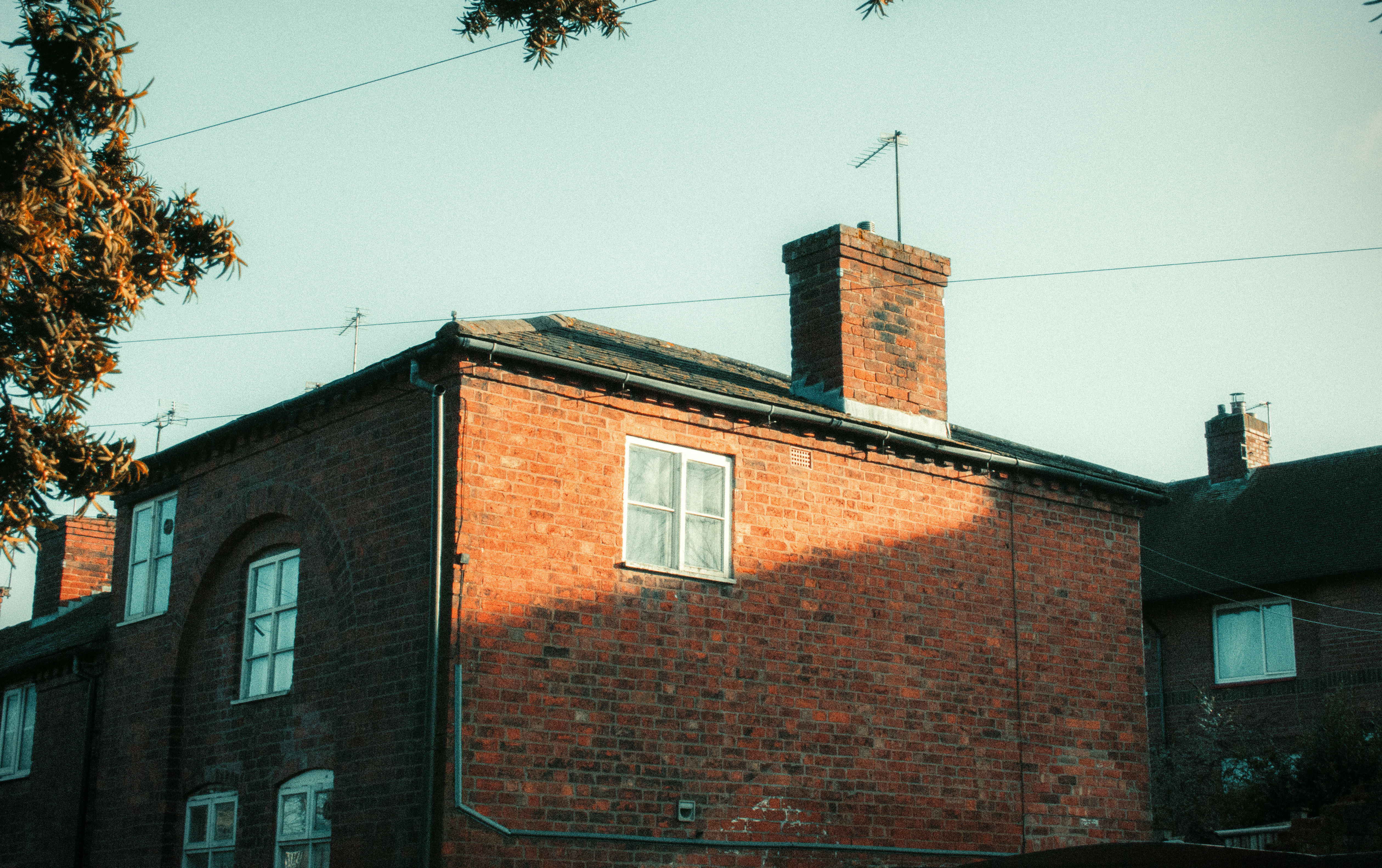 Charming brick architecture illuminated by warm afternoon sunlight in England.