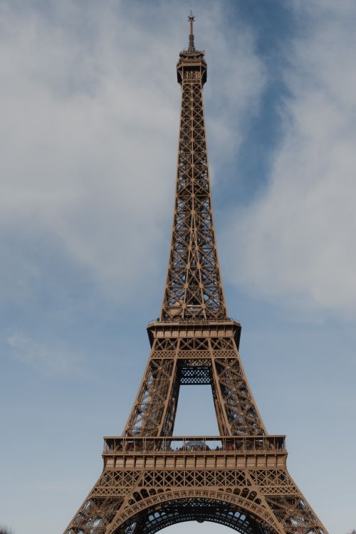 Free Majestic view of the Eiffel Tower in Paris against a clear blue sky, perfect for travel inspiration. Stock Photo