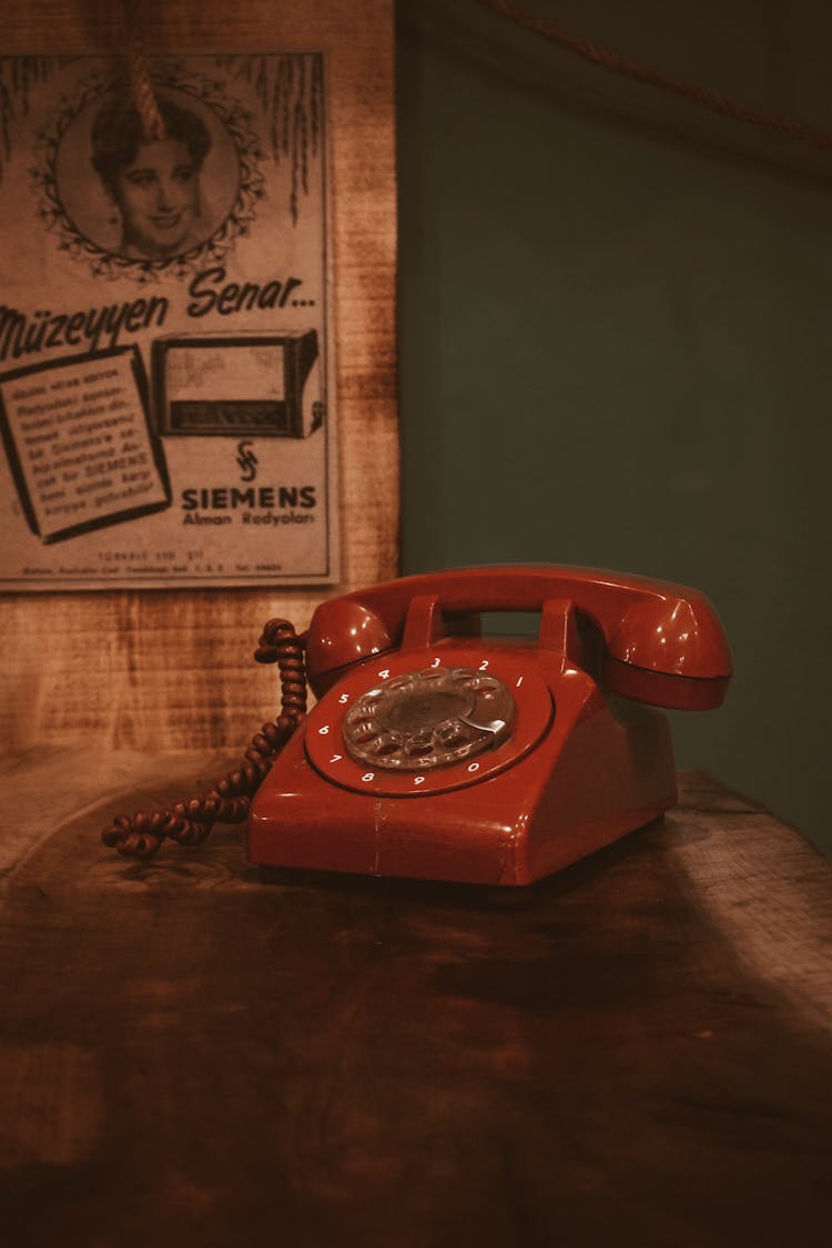 Retro Telephone On Table In Darkened Room