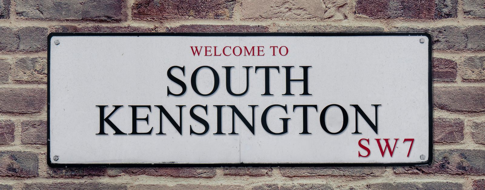 Street sign for South Kensington, London, UK, showcasing local charm.