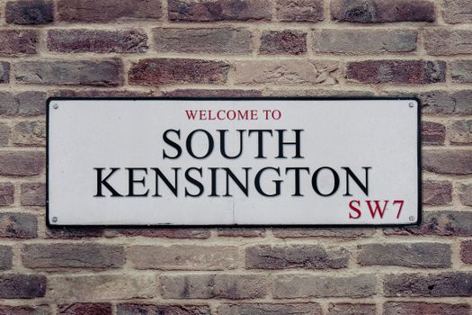 Street sign for South Kensington, London, UK, showcasing local charm.