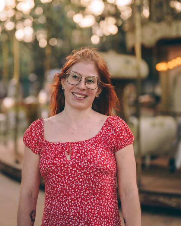 Smiling Woman in Red Floral Dress at Carousel · Free Stock Photo