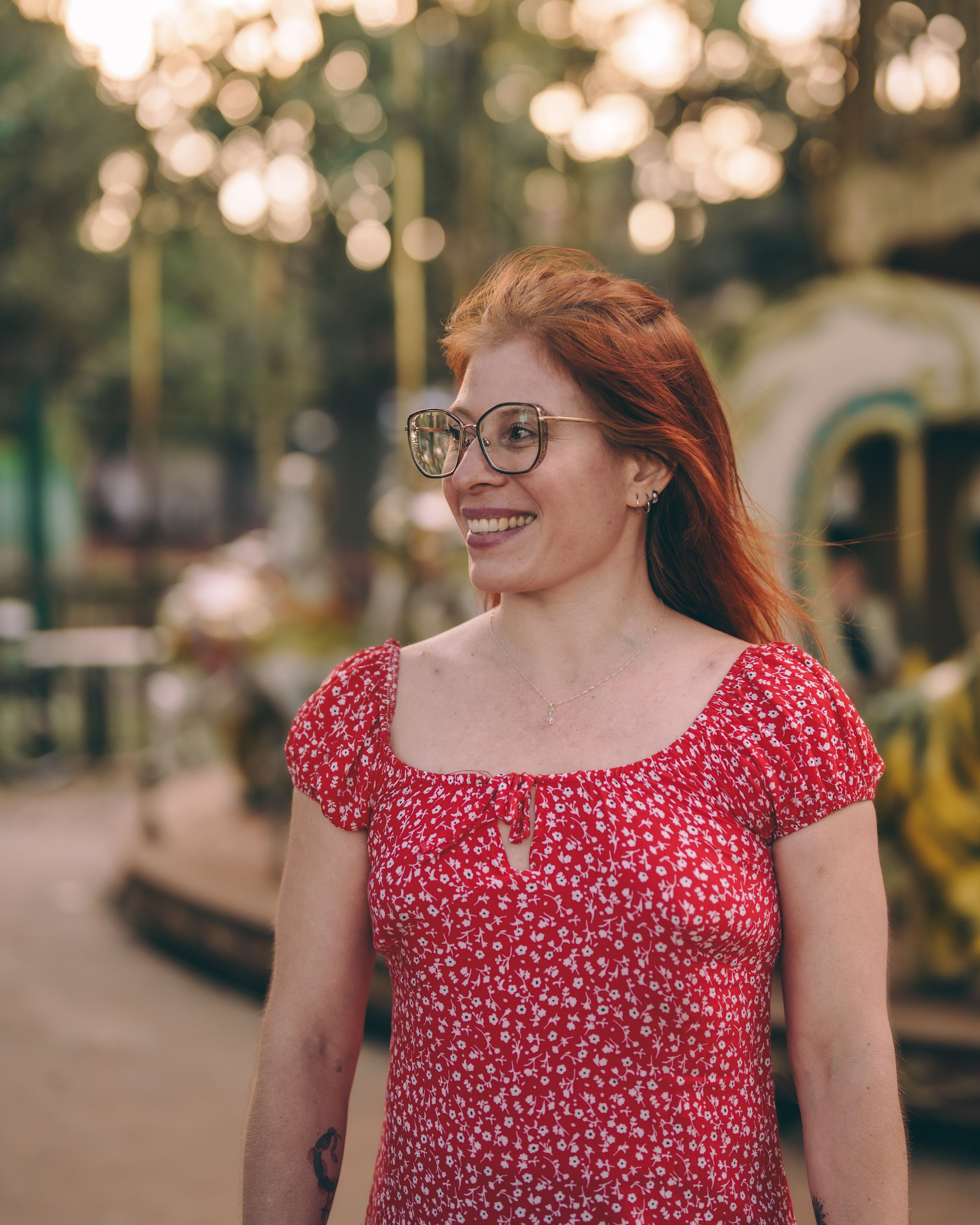 Woman in Red Dress at Amusement Park Carousel · Free Stock Photo