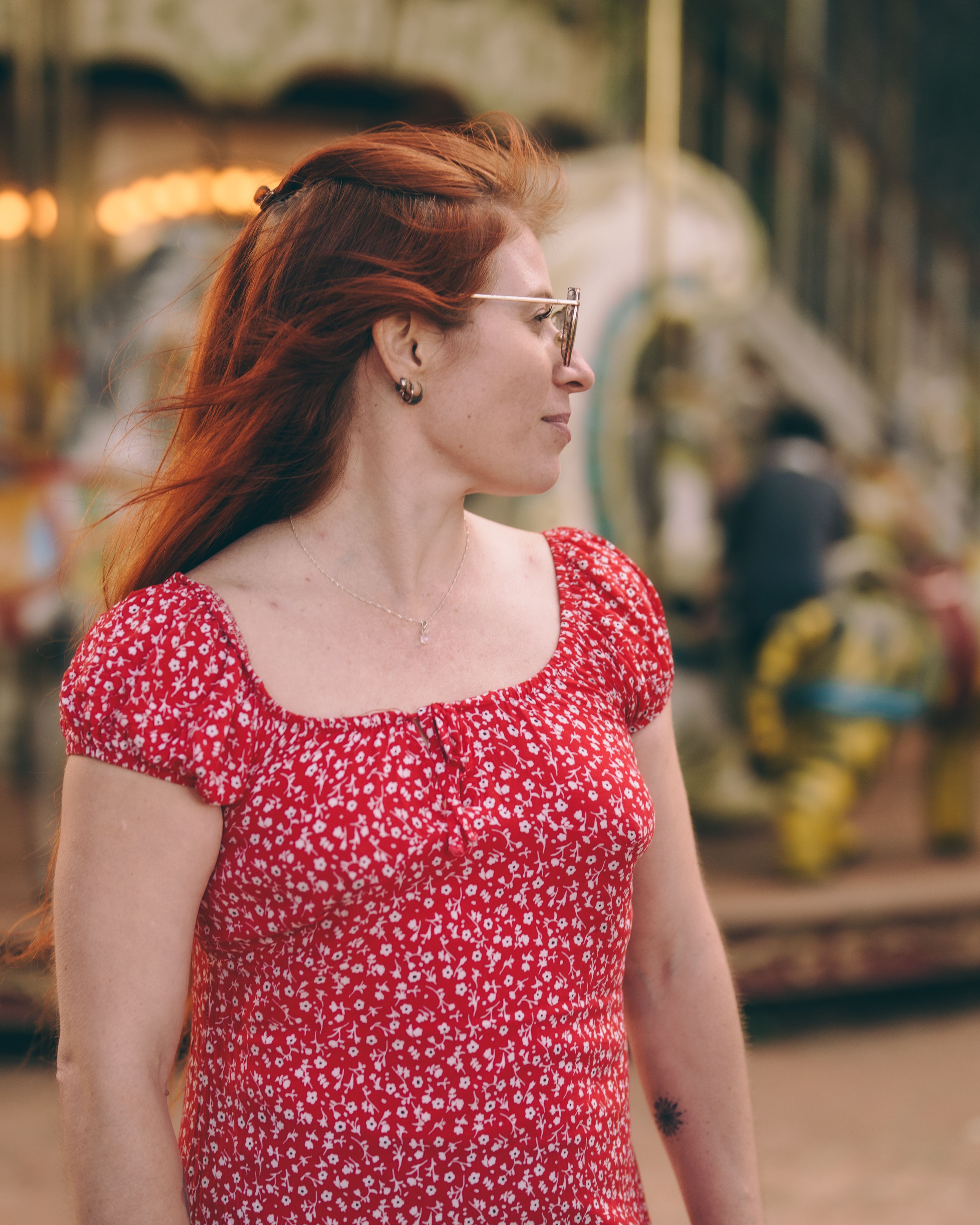 Woman in Red Dress at Amusement Park Carousel · Free Stock Photo