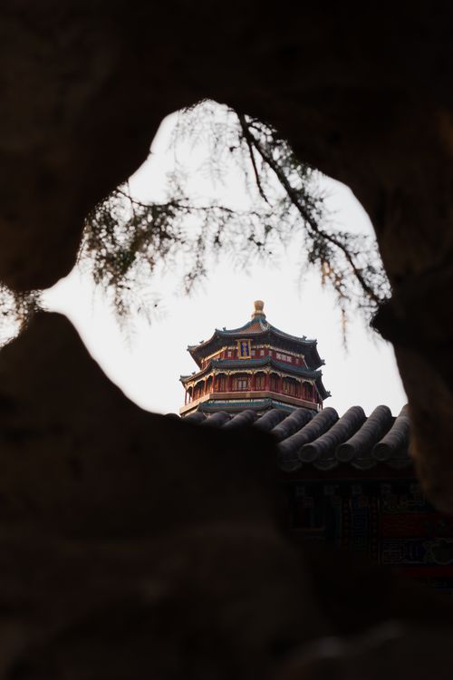 Free View of a traditional Chinese pavilion through rock formations at the Summer Palace, Beijing. Stock Photo