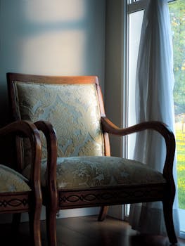 A classic vintage armchair bathed in soft natural light, creating a warm, inviting atmosphere indoors.