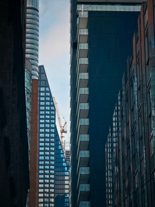 Free Contemporary skyscrapers and construction crane in an urban cityscape. Stock Photo