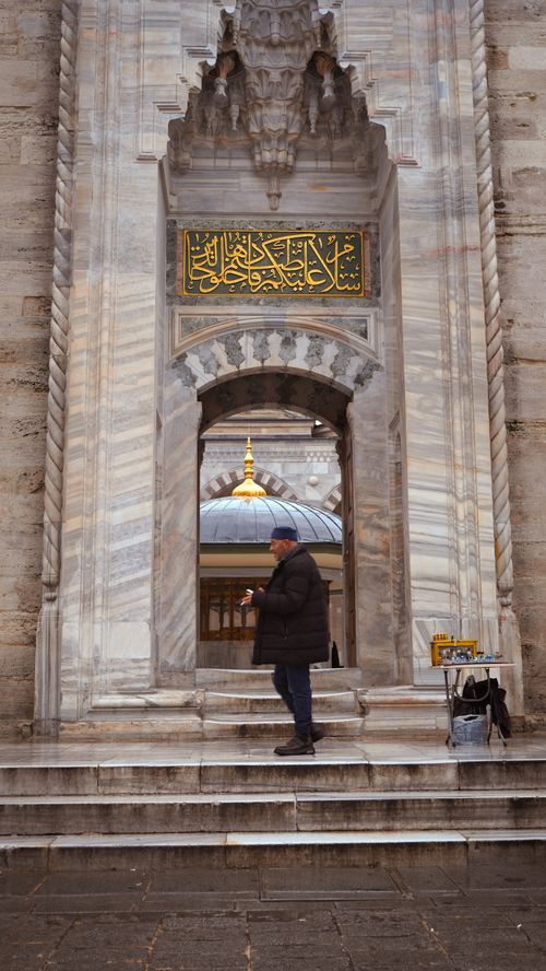 Free A person stands at the entrance of a historic mosque in Istanbul, featuring ornate architecture. Stock Photo
