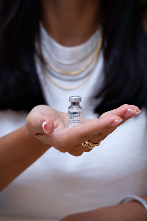 Free A woman holding a Botox vial, showcasing cosmetic and beauty treatments. Stock Photo