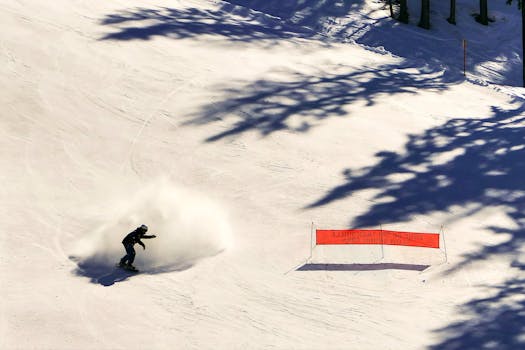 Dynamic snowboarding scene in French Alps with powder spray. Perfect for winter sports enthusiasts.