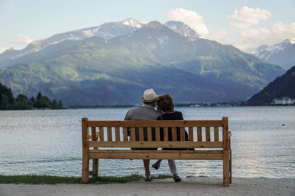A Canadian couple discussing their future retirement plans while looking out at a mountain landscape