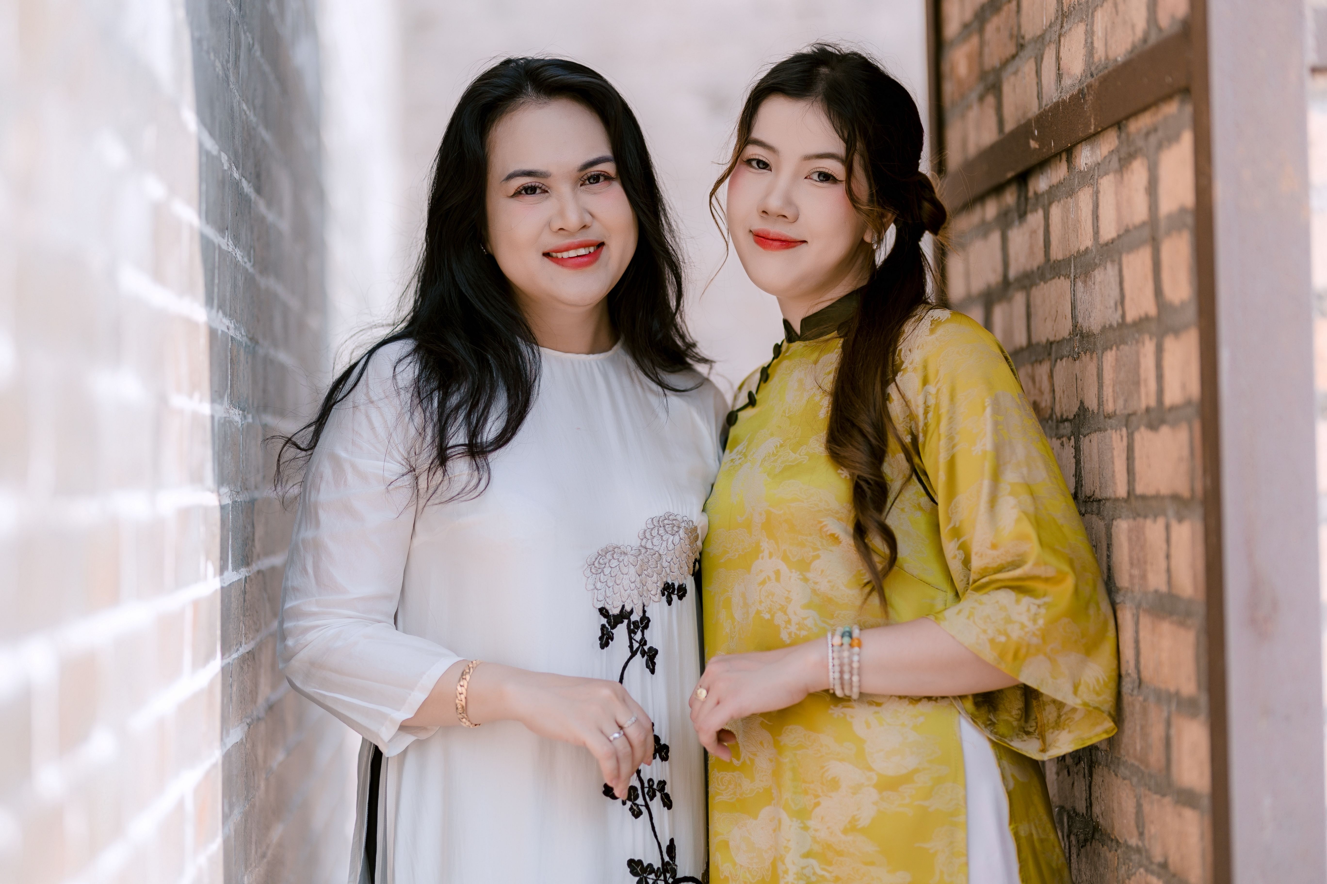 Two Women Smiling in Traditional Attire · Free Stock Photo