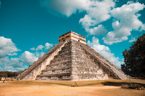 Free The iconic El Castillo pyramid at Chichen Itza, Mexico, captured on a sunny day with a vibrant blue sky. Stock Photo