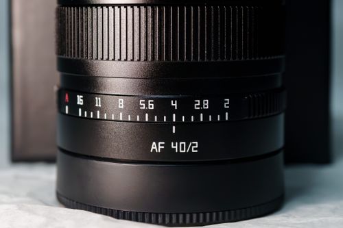 Free Close-up of professional AF 40/2 camera lens with visible aperture settings under studio lighting. Stock Photo