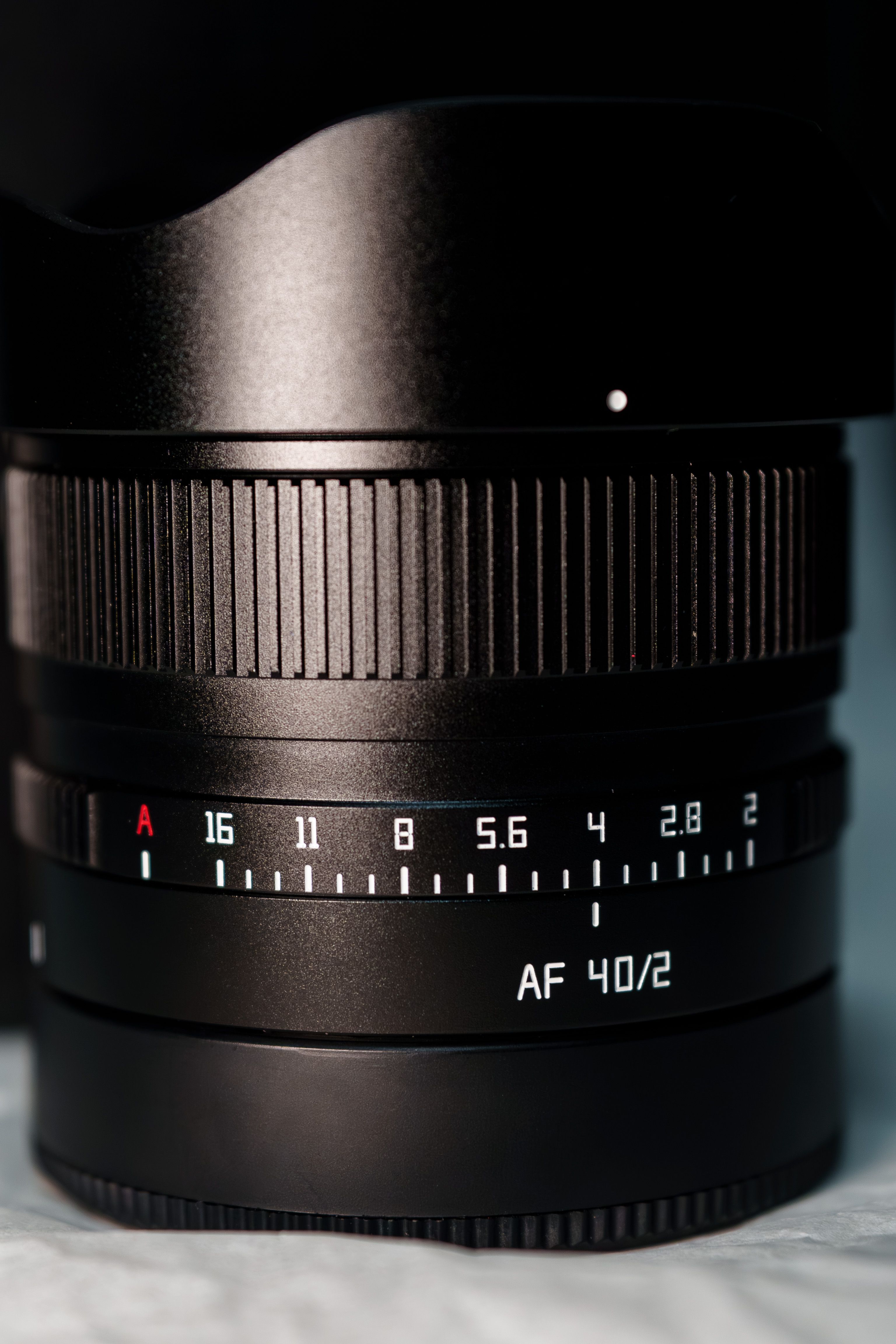 Detailed view of a camera lens highlighting aperture markings and focus ring.