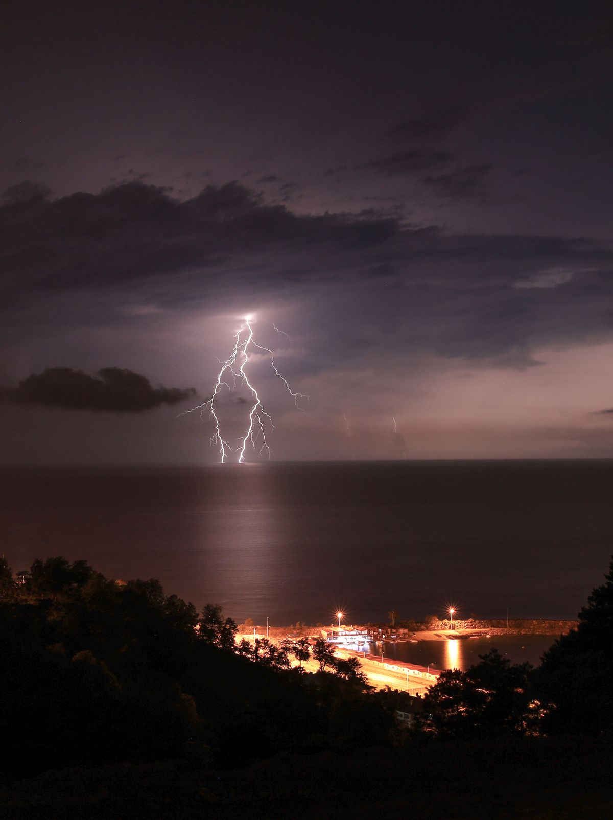 Dramatic Lightning Strike Over Tranquil Sea · Free Stock Photo