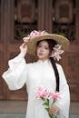 Elegant Woman with Lilies and Straw Hat Portrait