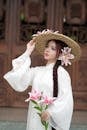 Elegant Woman with Flowers and Straw Hat