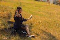 Stylish Woman in Black Dress Relaxing Outdoors