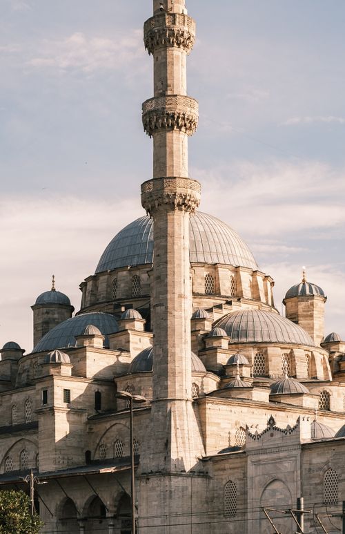 Free Beautiful view of an Ottoman-style mosque with minarets against a pastel sky, captured at golden hour. Stock Photo