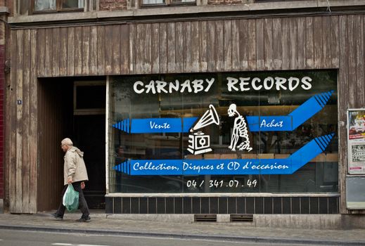 Street view of Carnaby Records with an elderly man walking by.