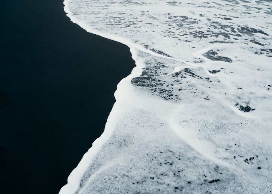 A captivating view of an icy ocean surface with snow and frost, showcasing winter scenery.