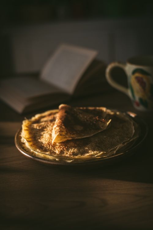 Free Delicious homemade crepes on a wooden table in warm, natural light. Stock Photo