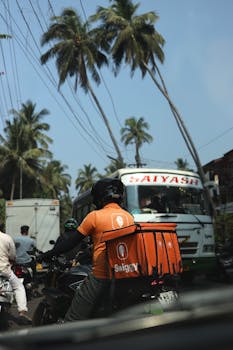 A Swiggy delivery driver navigating through the busy streets of Goa, India.