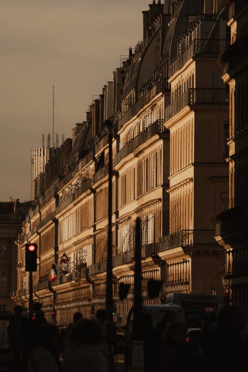 Free Capture of sunlit Parisian buildings during golden hour, featuring classic architecture and urban life. Stock Photo