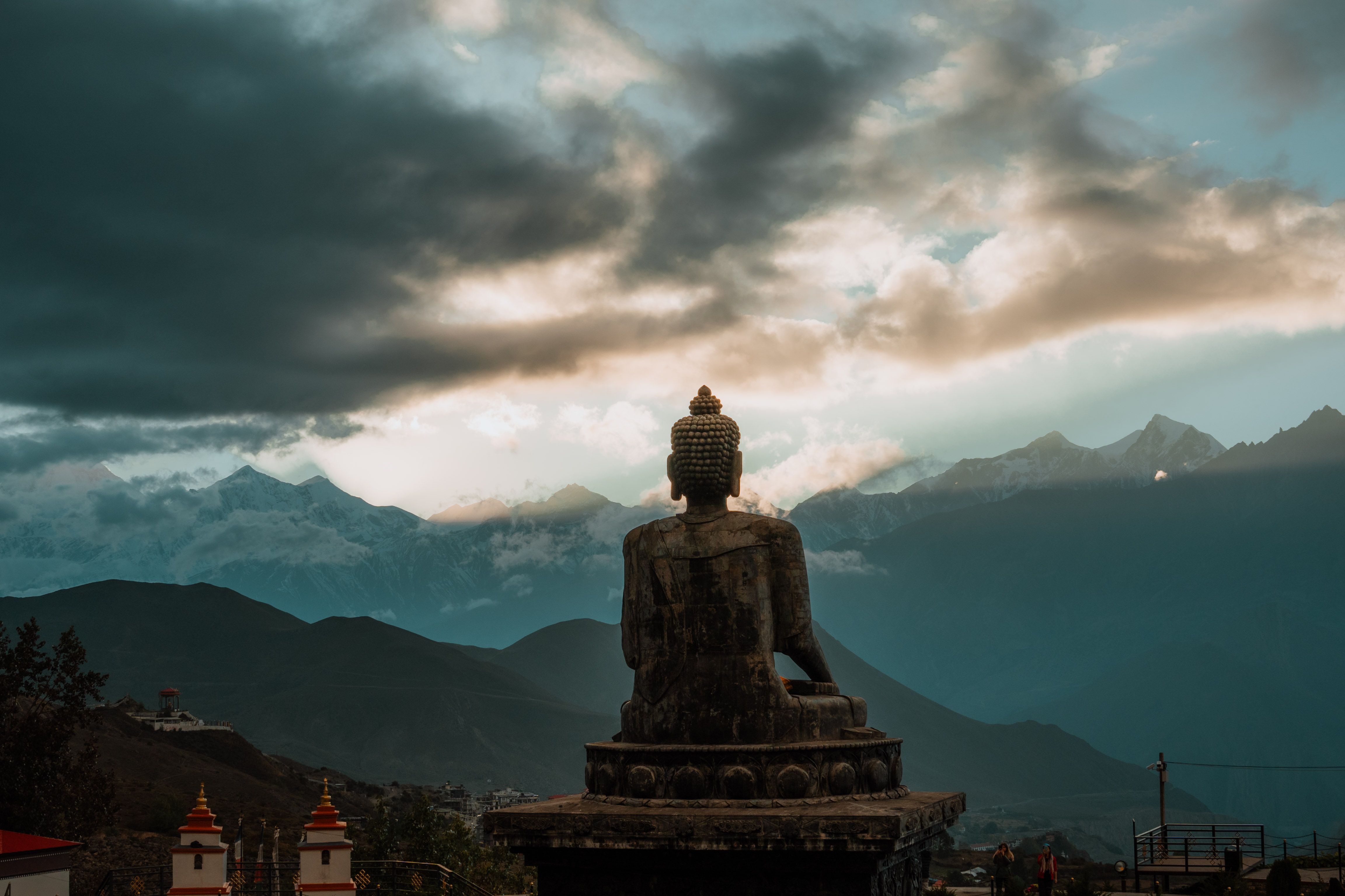 A golden sunset over the Xingguo Temple Zhangba Buddha, with green fields in the background
