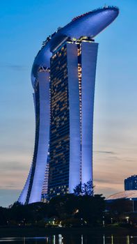 A stunning view of Marina Bay Sands illuminated against the evening sky in Singapore.