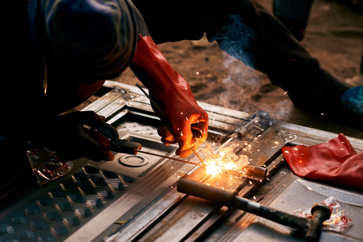 Close-up of an industrial worker welding metal