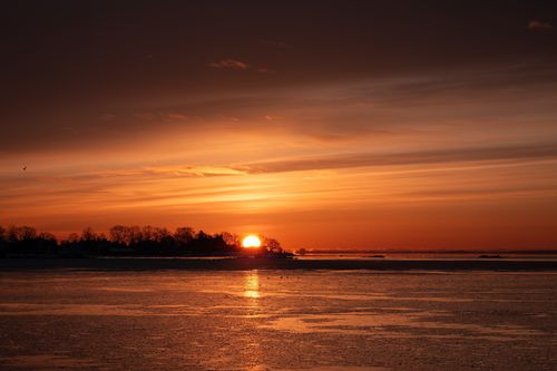 Free Captivating winter sunrise over the icy coastline of Stamford, Connecticut with vivid orange hues. Stock Photo