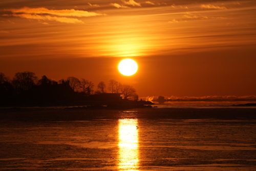 Free Breathtaking sunset view over tranquil water at dusk with glowing sky. Stock Photo