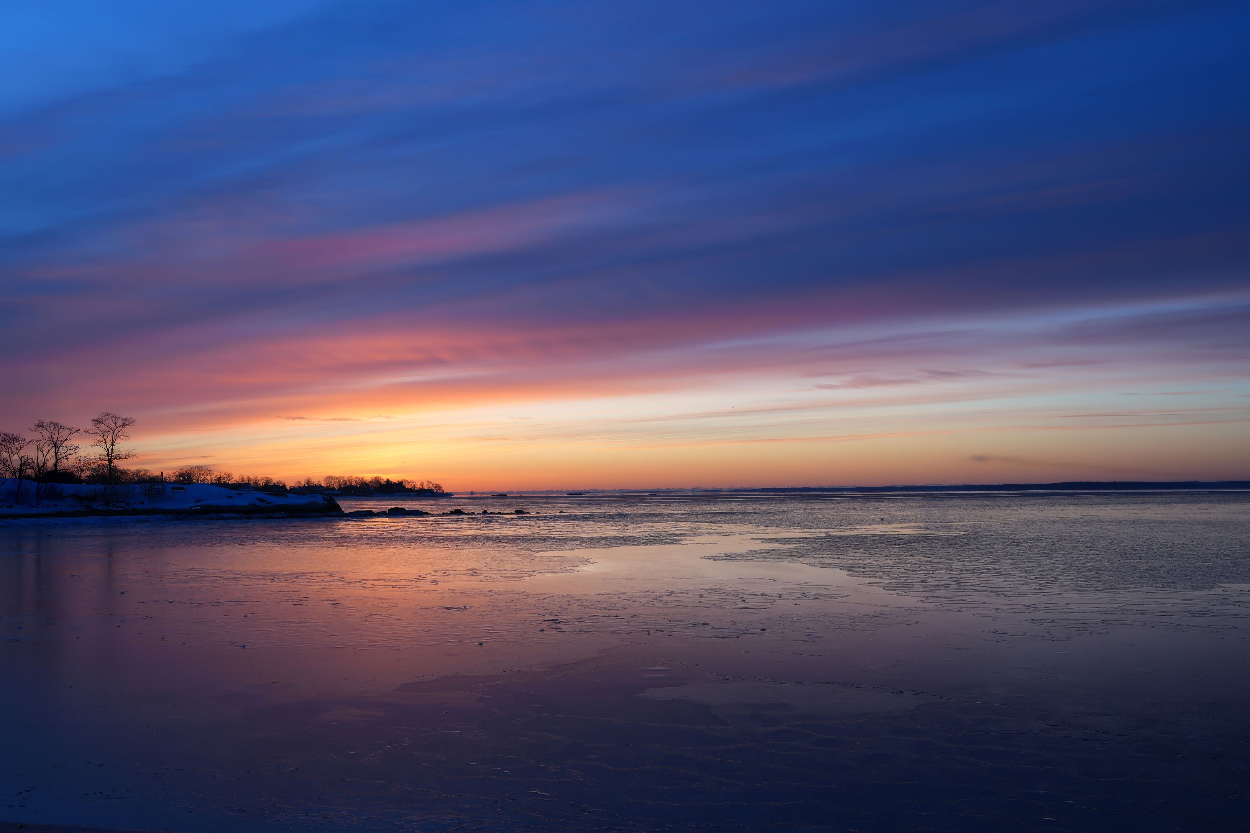 Serene Winter Sunset Over a Frozen Lake · Free Stock Photo