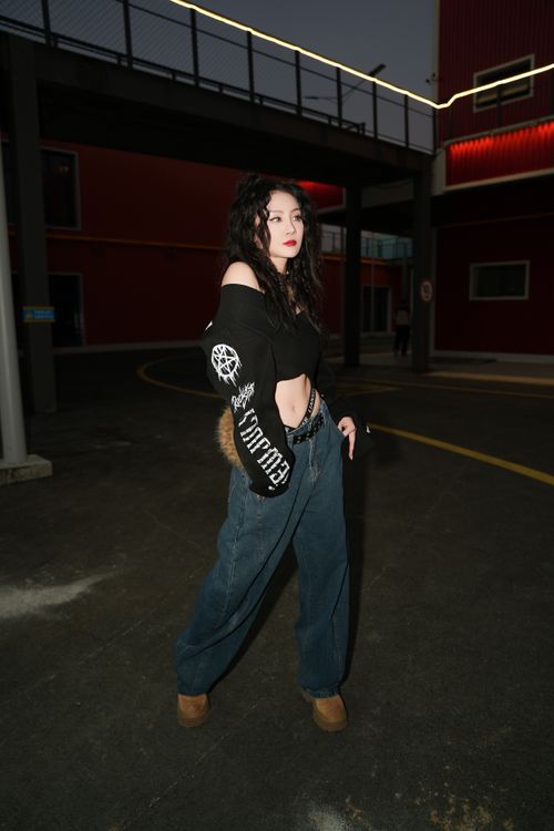 Stylish Young Woman Posing in Urban Setting at Night · Free Stock Photo