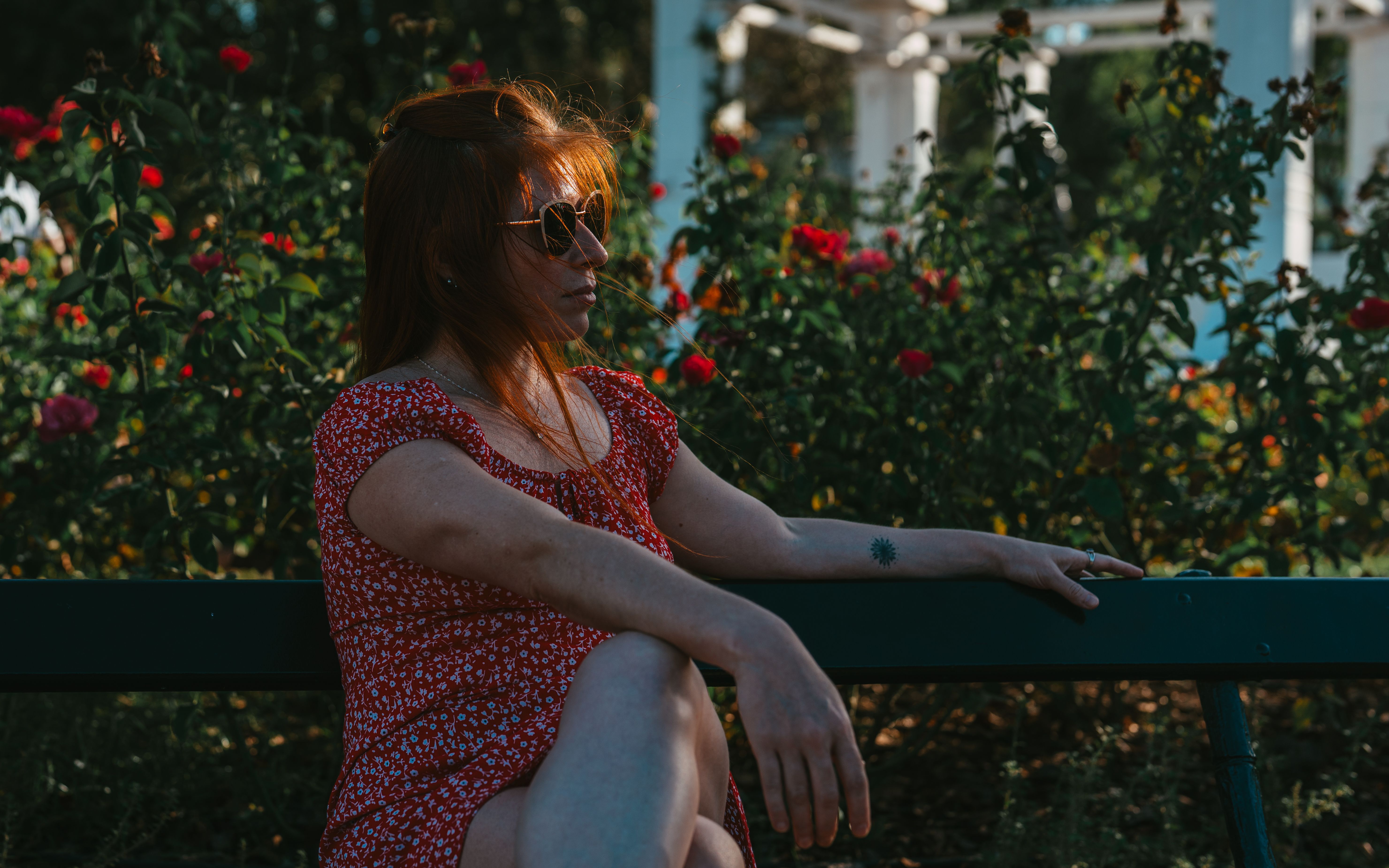 Relaxed Woman on Park Bench with Roses · Free Stock Photo