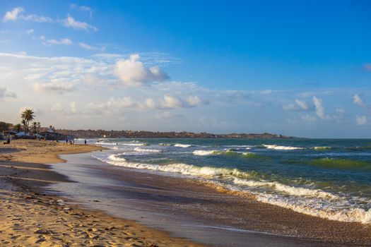 Beautiful sandy beach under blue sky in Maxaranguape, Brazil, capturing the essence of tranquility.